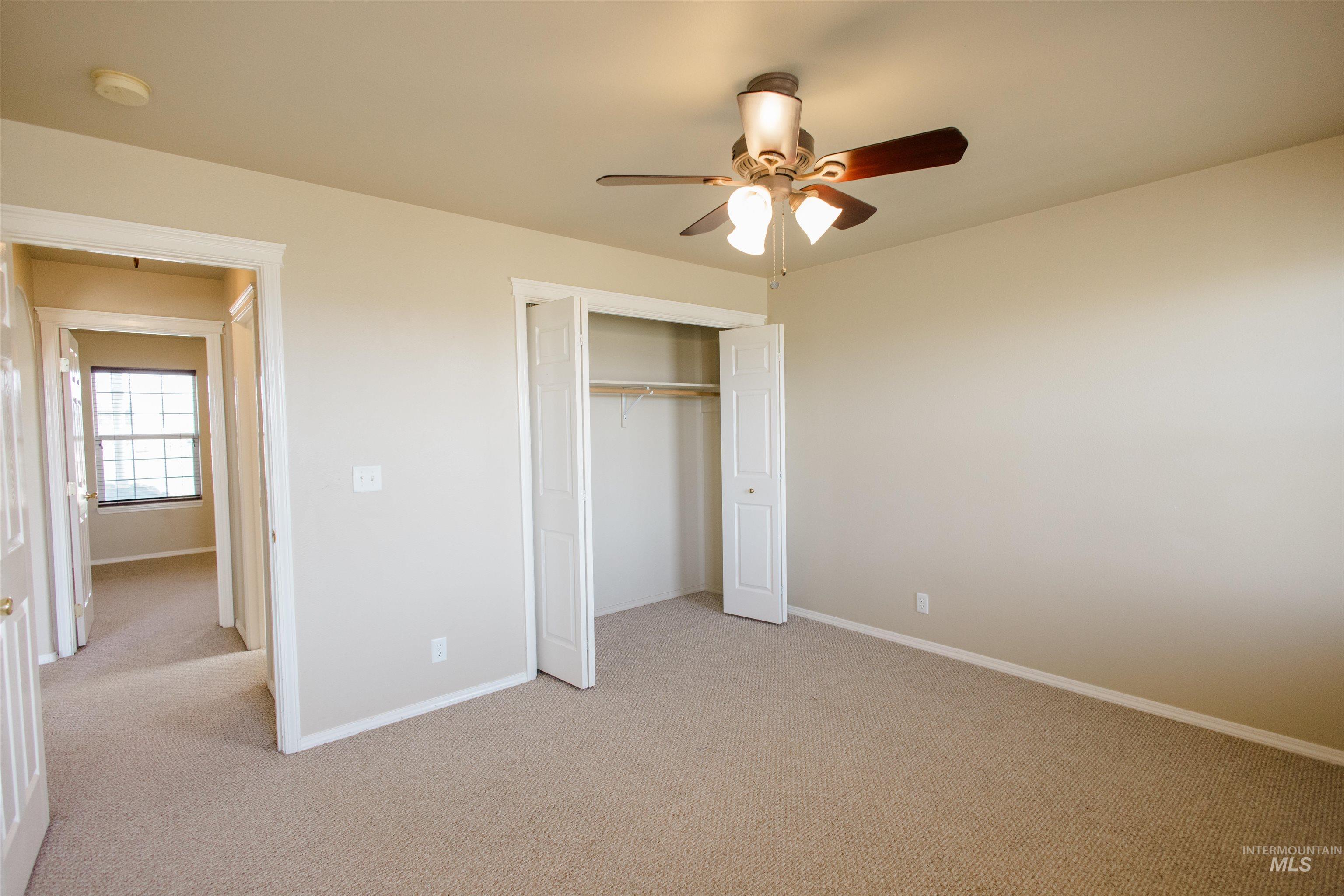1571 Southeast Hamilton Road Mountain Home, ID 83647 - Photo 27 of 50 Unfurnished bedroom featuring light colored carpet, a closet, and a ceiling fan