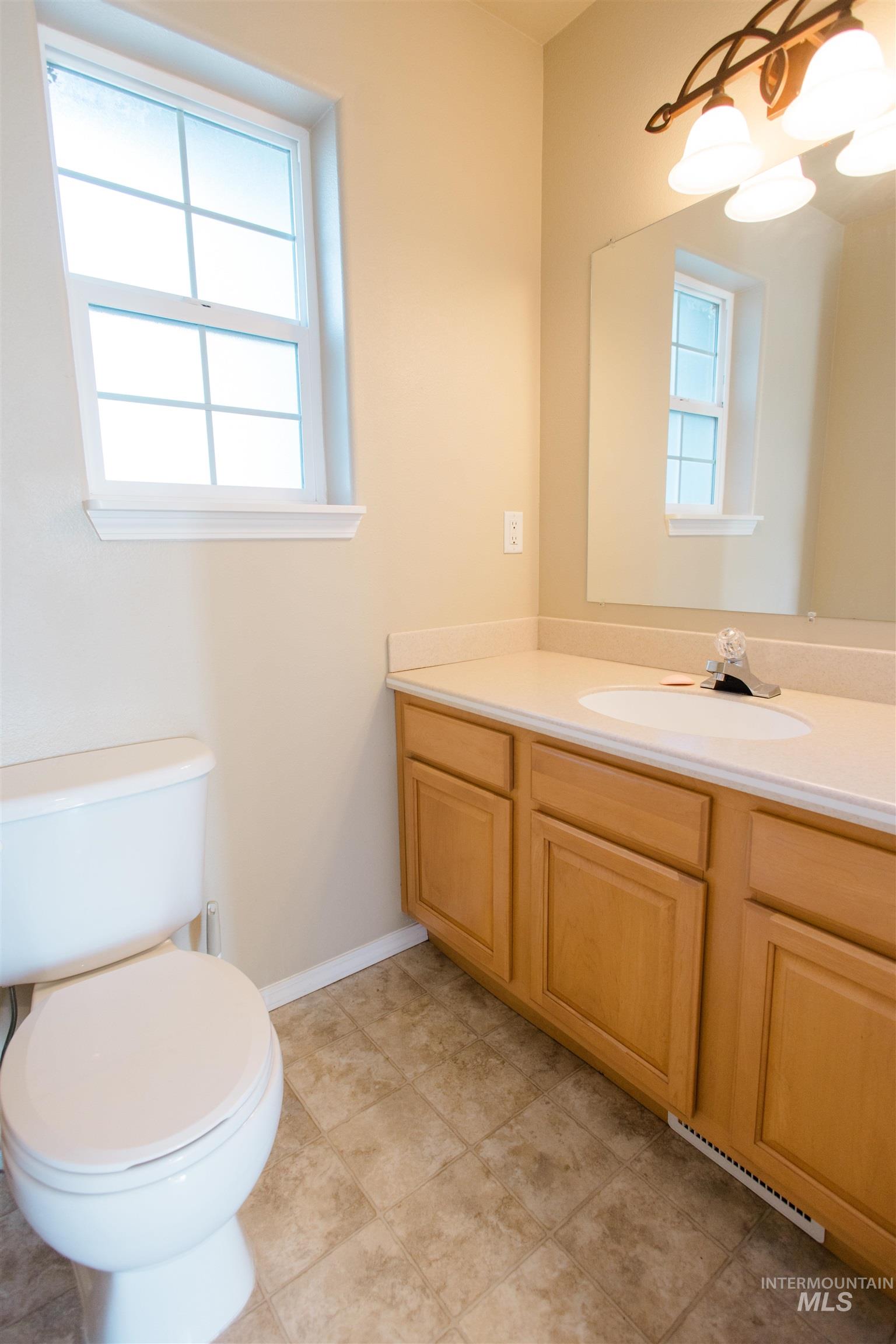 1571 Southeast Hamilton Road Mountain Home, ID 83647 - Photo 33 of 50 Bathroom with toilet and vanity