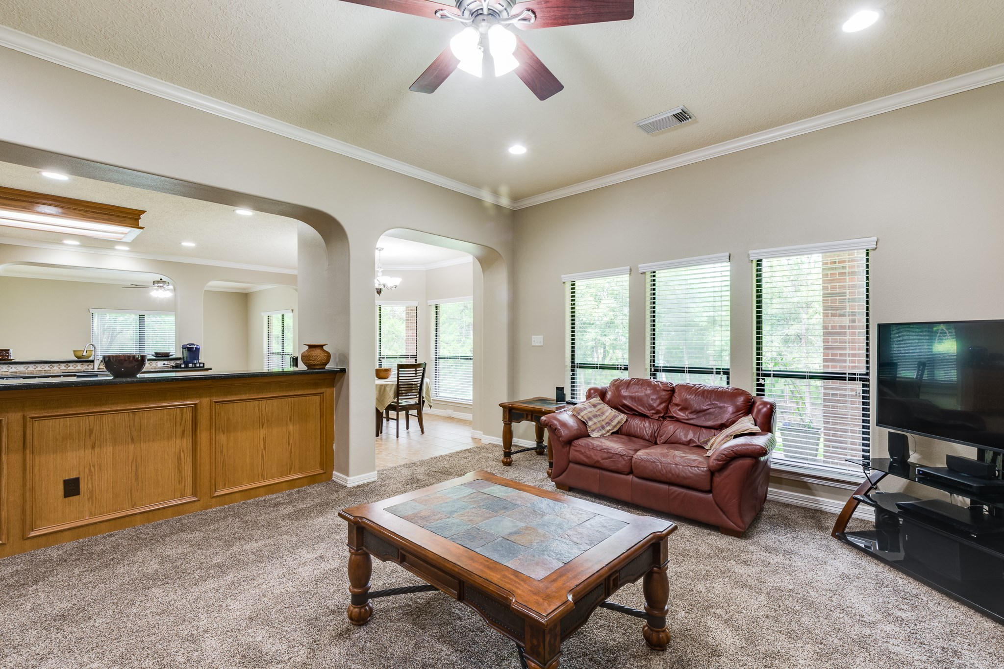 507 Oaks Grande Road Baytown, TX 77523 - Photo 14 of 50 a living room with furniture and a flat screen tv