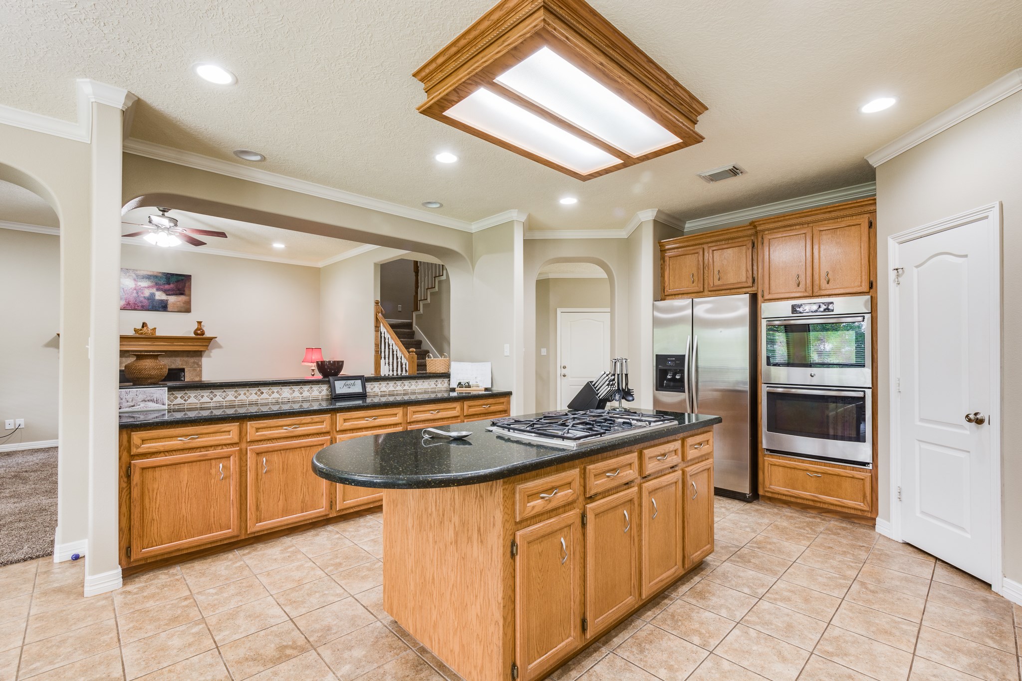 507 Oaks Grande Road Baytown, TX 77523 - Photo 16 of 50 a kitchen with stainless steel appliances granite countertop a stove sink and cabinets