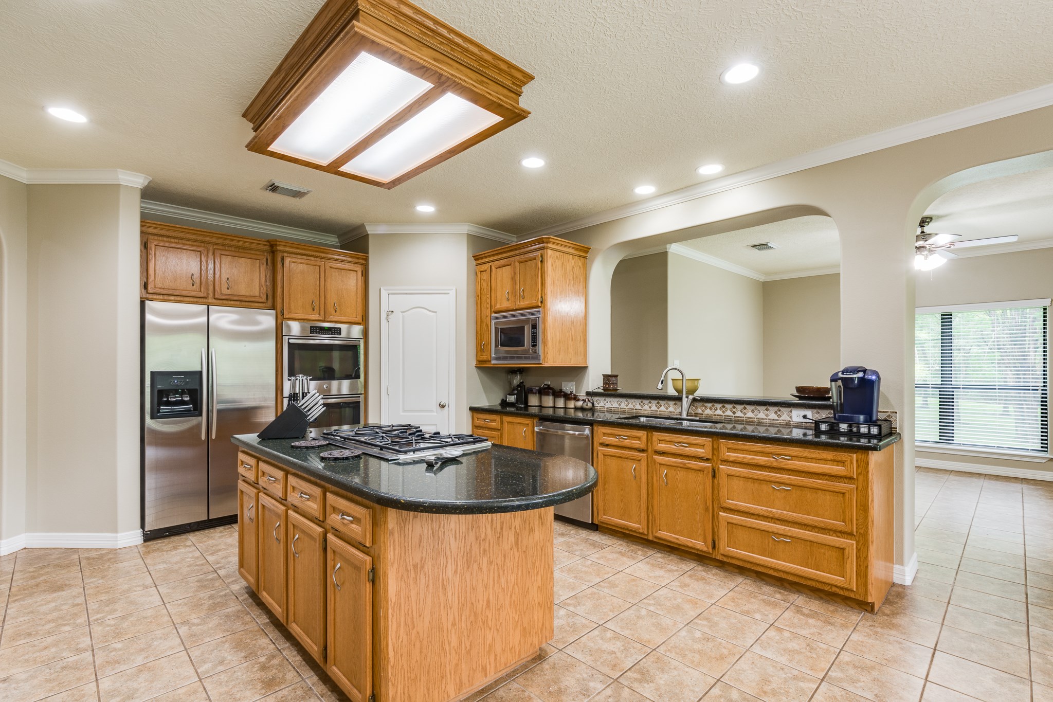 507 Oaks Grande Road Baytown, TX 77523 - Photo 20 of 50 a kitchen with stainless steel appliances granite countertop a stove a sink dishwasher and a refrigerator