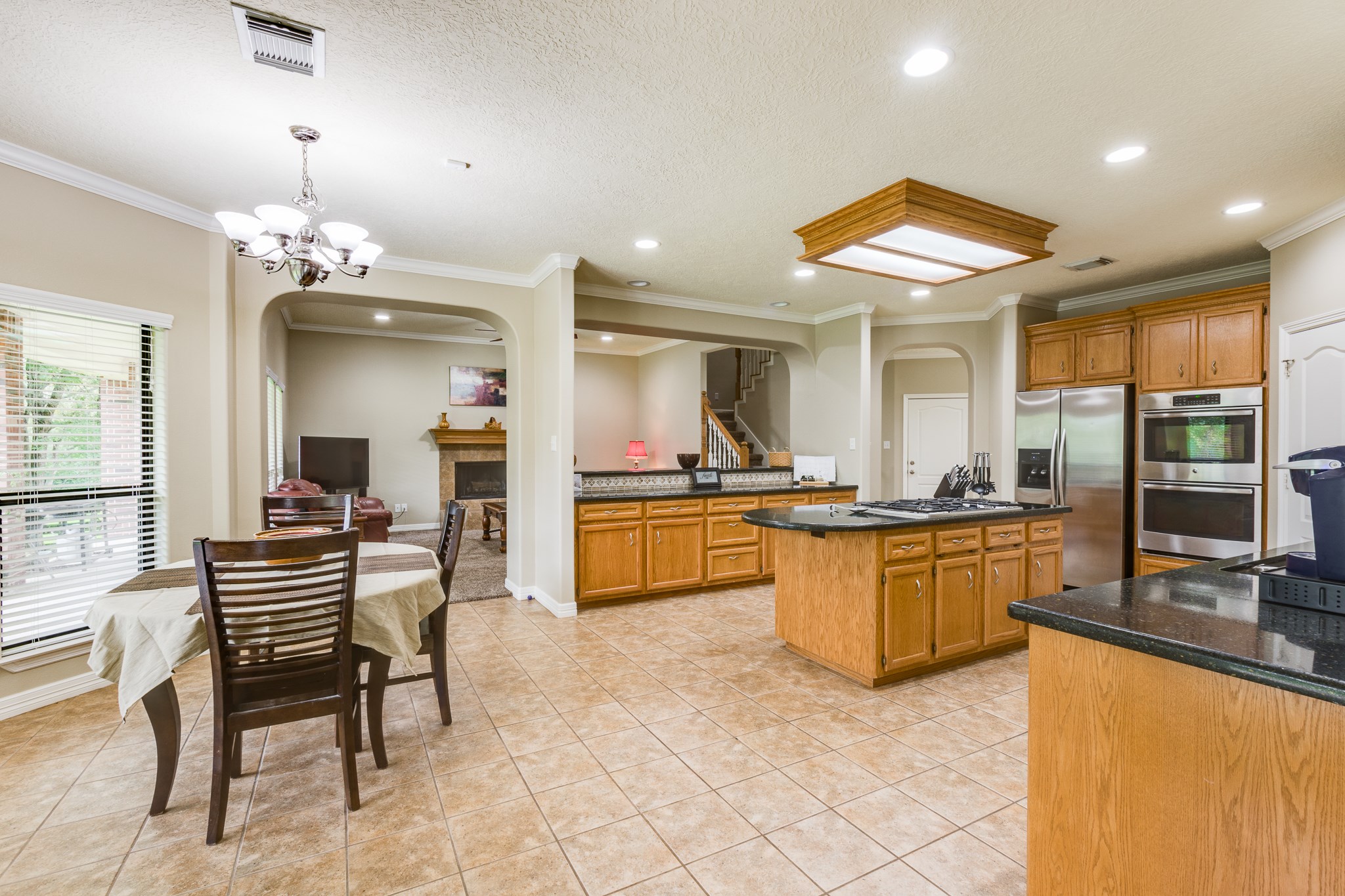 507 Oaks Grande Road Baytown, TX 77523 - Photo 2 of 50 a kitchen with stainless steel appliances kitchen island granite countertop a sink and cabinets