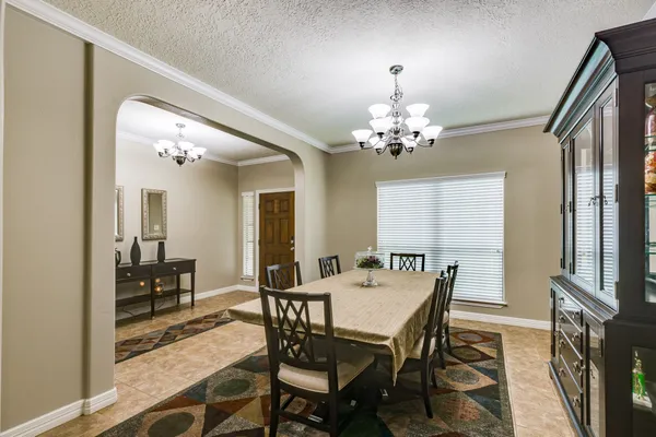 a view of a dining room with furniture and a chandelier
