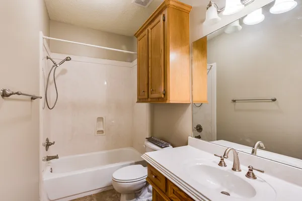 a bathroom with a sink toilet tub and shower
