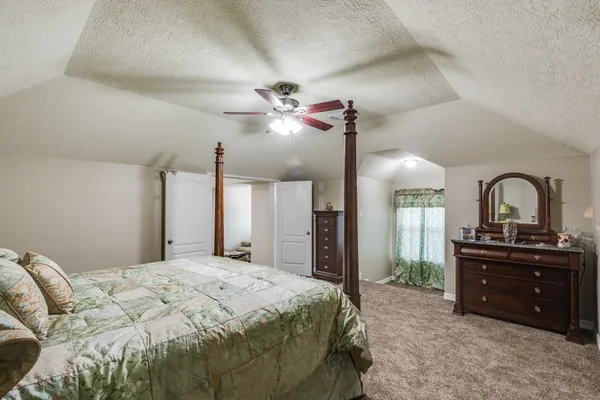 a bedroom with a bed and a dresser