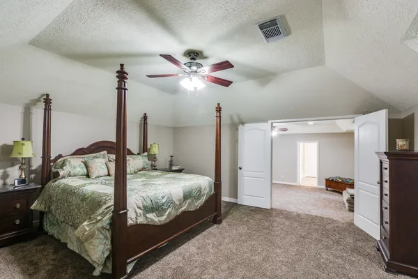a bedroom with a bed and a chandelier