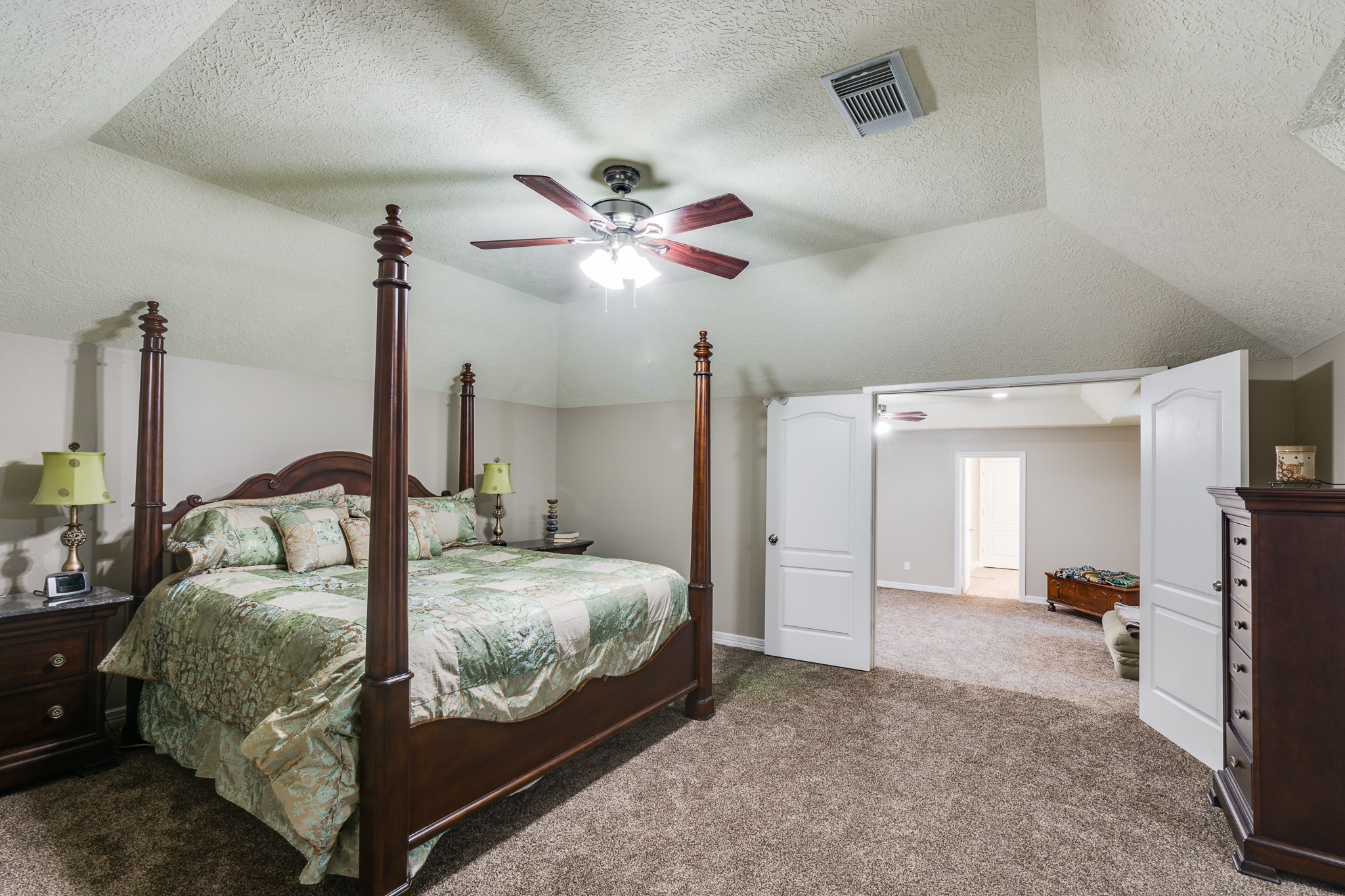 507 Oaks Grande Road Baytown, TX 77523 - Photo 30 of 50 a bedroom with a bed and a chandelier