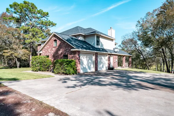 a front view of a house with a yard and a garage