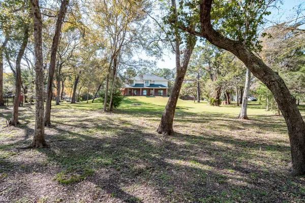 a big house with trees in front of it