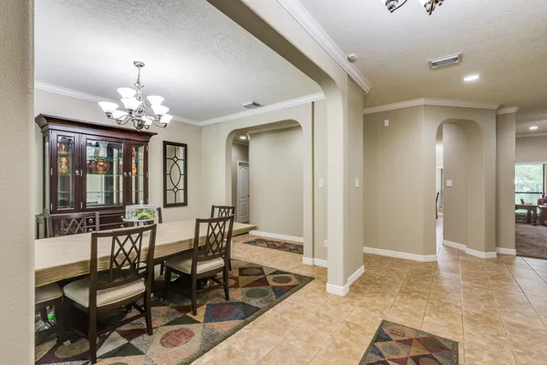 a view of a dining room with furniture and chandelier