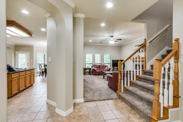 a view of a hallway with dining room and furniture