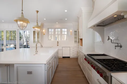 a kitchen with stainless steel appliances a sink stove and cabinets
