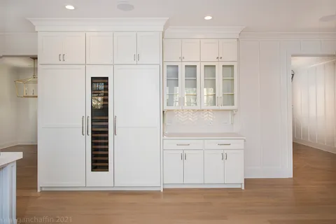 a view of empty room with wooden floor and cabinet