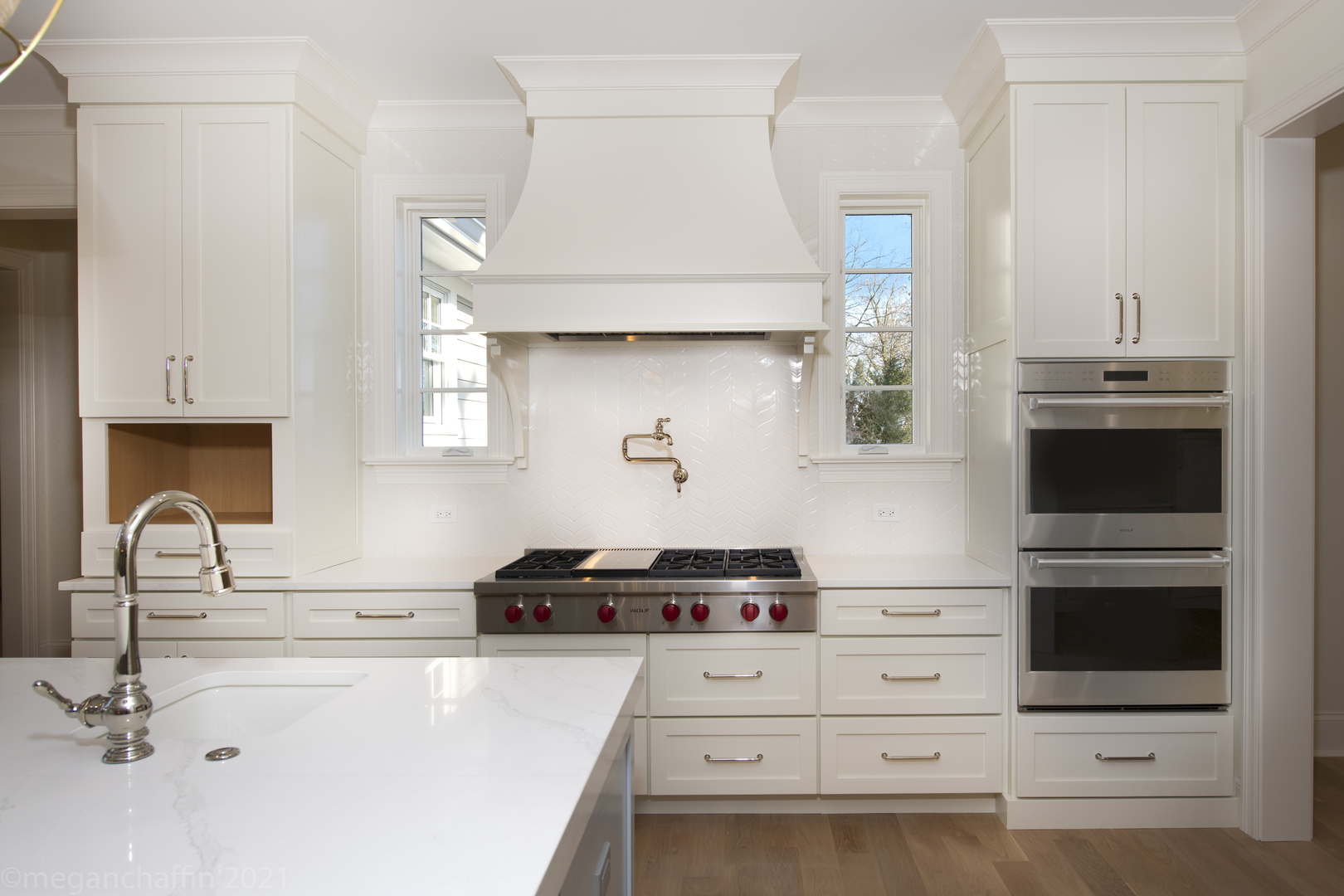 517 Cumnor Road Kenilworth, IL 60043 - Photo 7 of 24 a kitchen with white cabinets and appliances