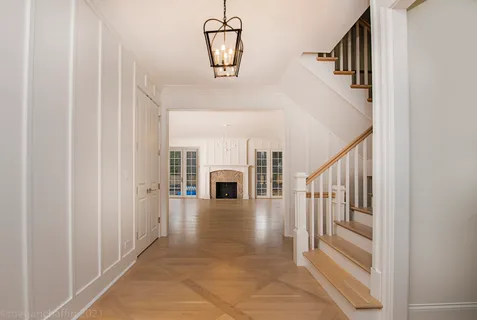 a view of entryway and hall with wooden floor