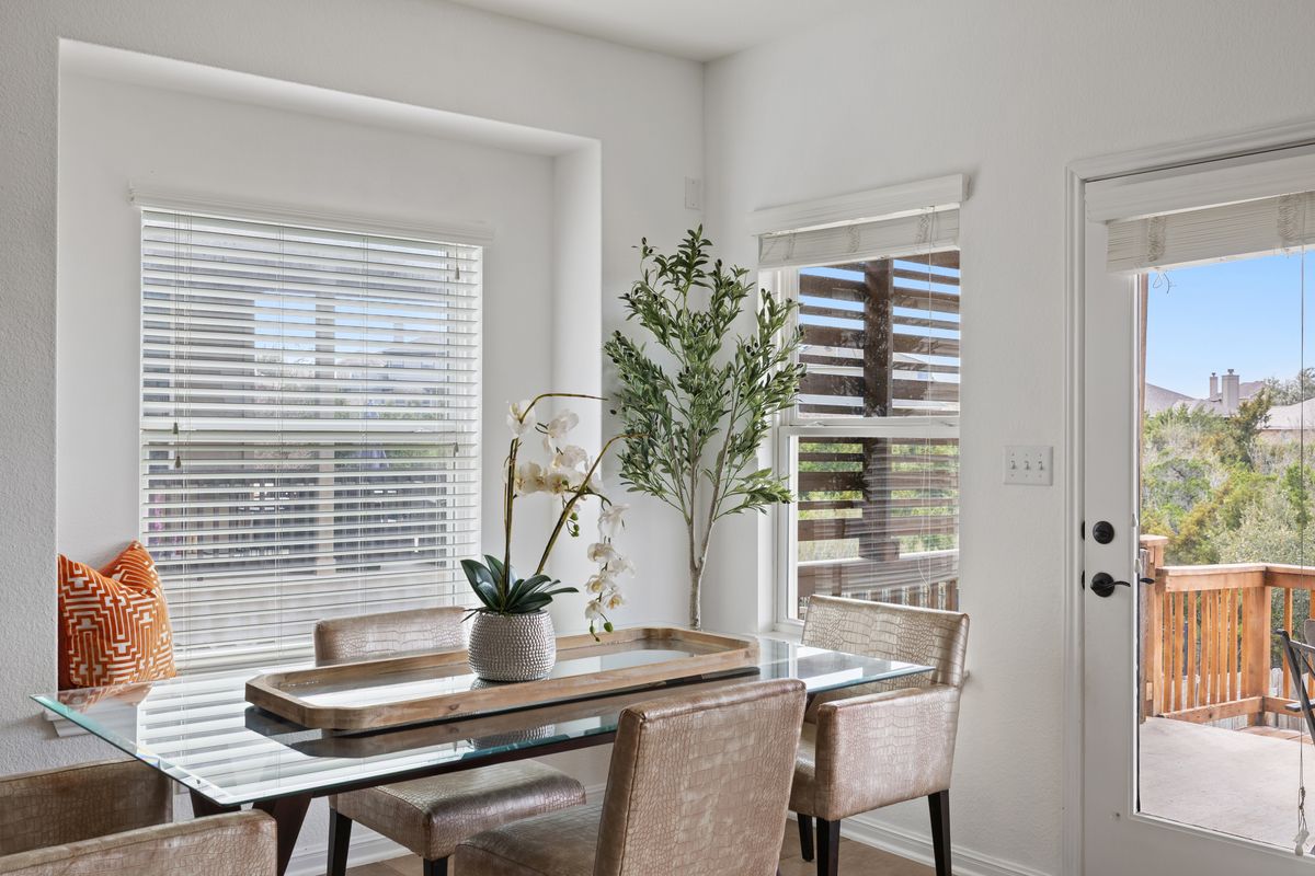 407 Stone View Trail Austin, TX 78737 - Photo 12 of 40 a dining room with furniture and potted plants