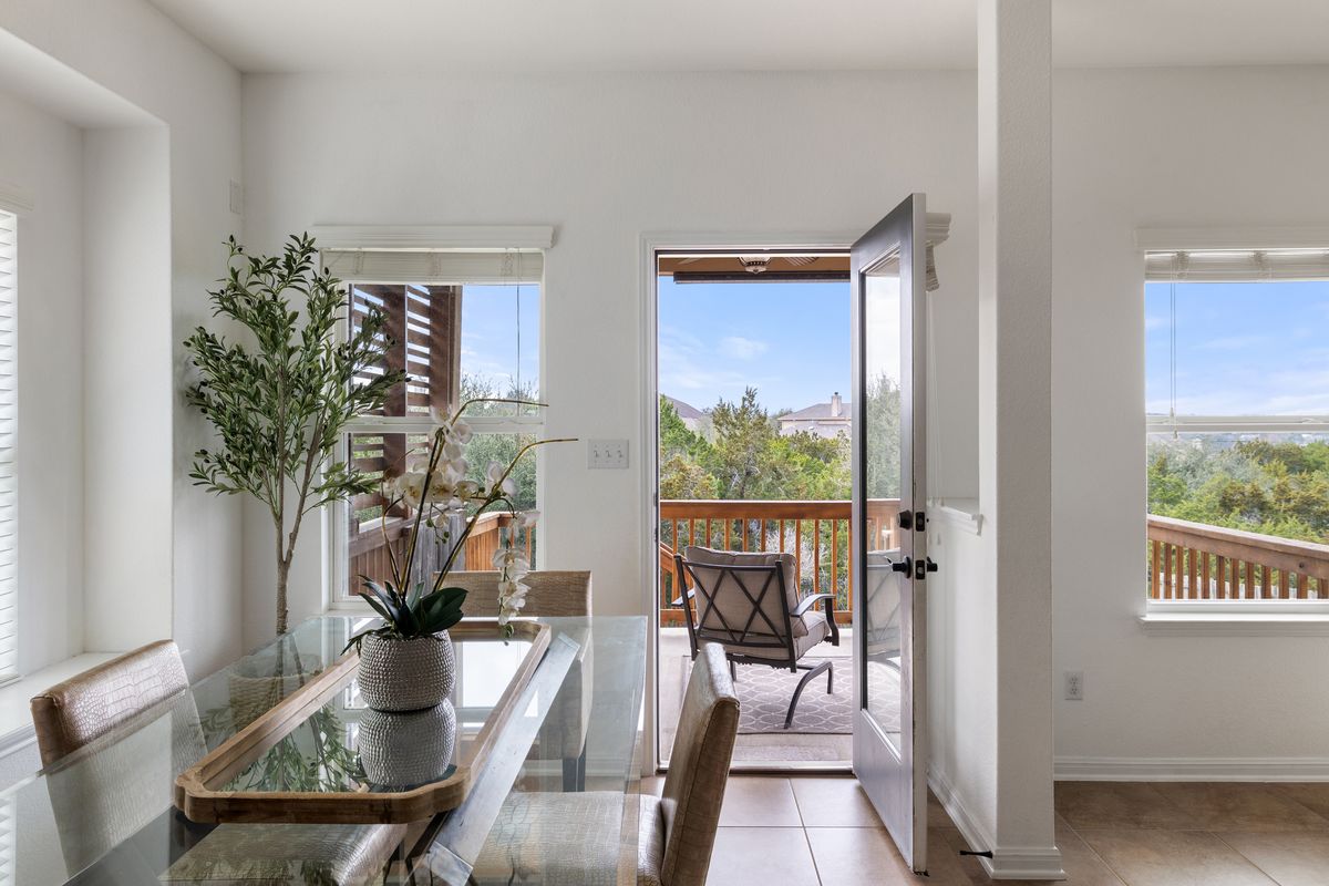407 Stone View Trail Austin, TX 78737 - Photo 13 of 40 a view of a dining room with furniture window and wooden floor