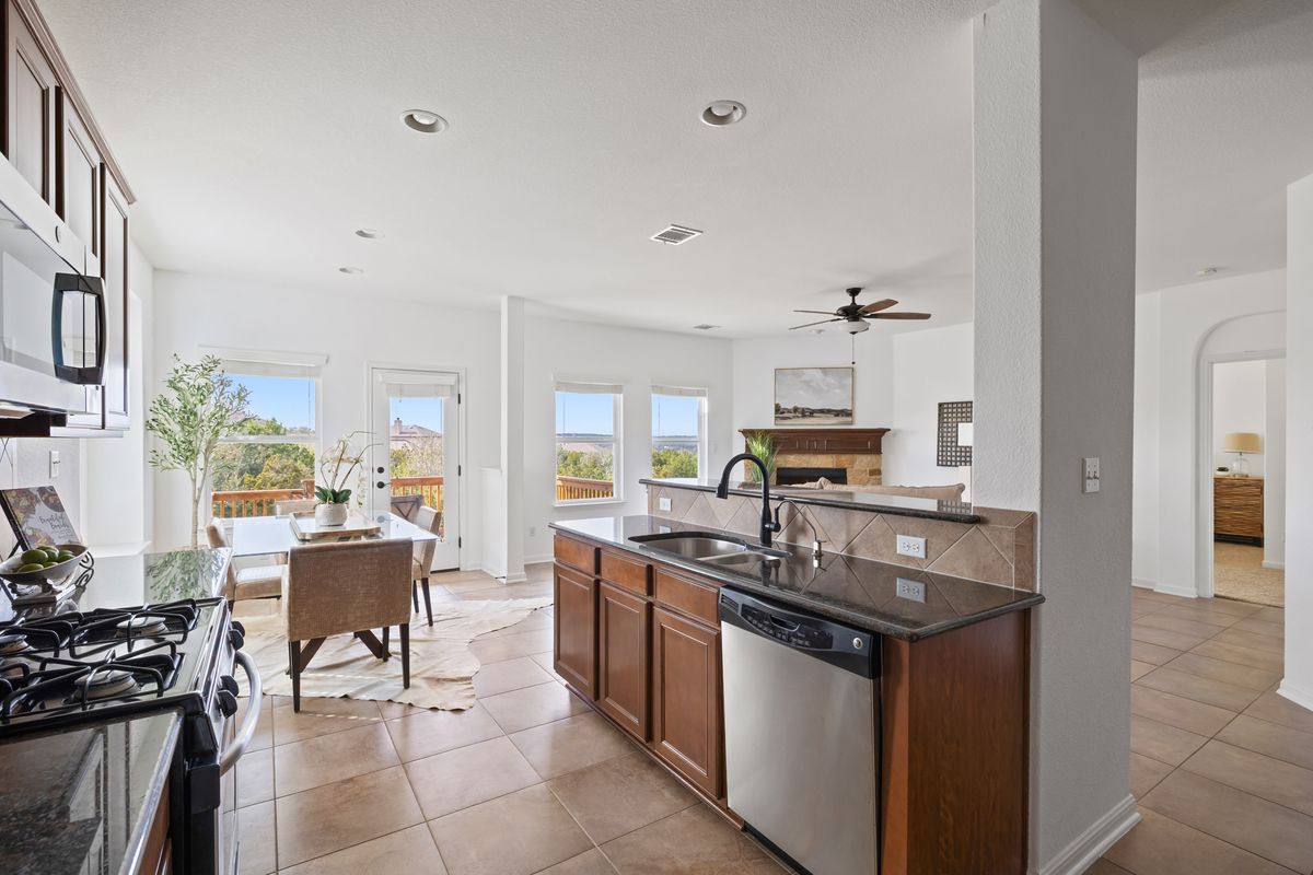 407 Stone View Trail Austin, TX 78737 - Photo 14 of 40 a kitchen with counter top space and appliances
