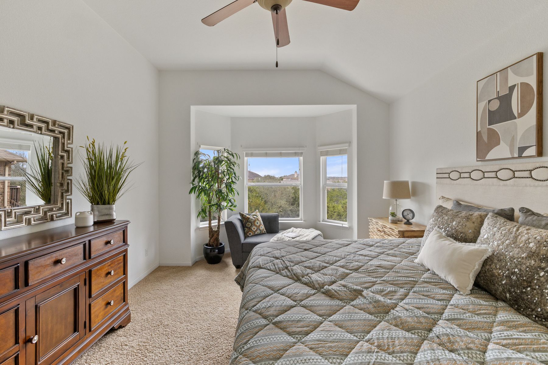 407 Stone View Trail Austin, TX 78737 - Photo 21 of 40 a bedroom with a large bed and a potted plant