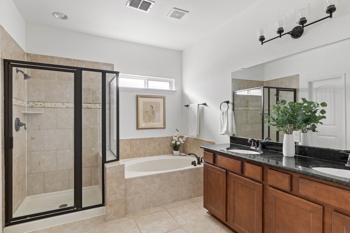 407 Stone View Trail Austin, TX 78737 - Photo 24 of 40 a spacious bathroom with a granite countertop tub mirror and shower