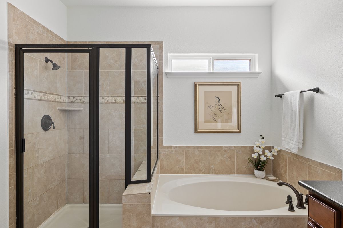 407 Stone View Trail Austin, TX 78737 - Photo 25 of 40 a bathroom with a bathtub and a shower