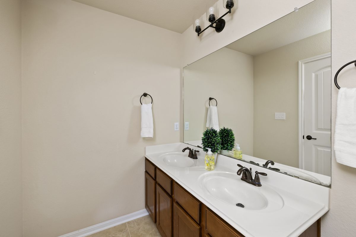 407 Stone View Trail Austin, TX 78737 - Photo 33 of 40 a bathroom with a sink and a mirror