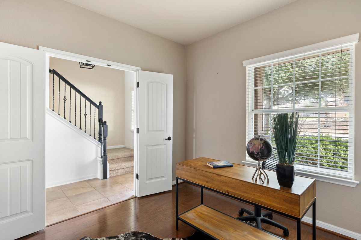 407 Stone View Trail Austin, TX 78737 - Photo 6 of 40 a view of a workspace with furniture and a window