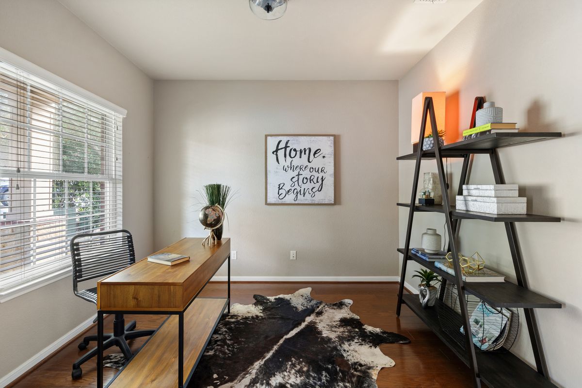 407 Stone View Trail Austin, TX 78737 - Photo 7 of 40 a bedroom with a bed and wooden floor