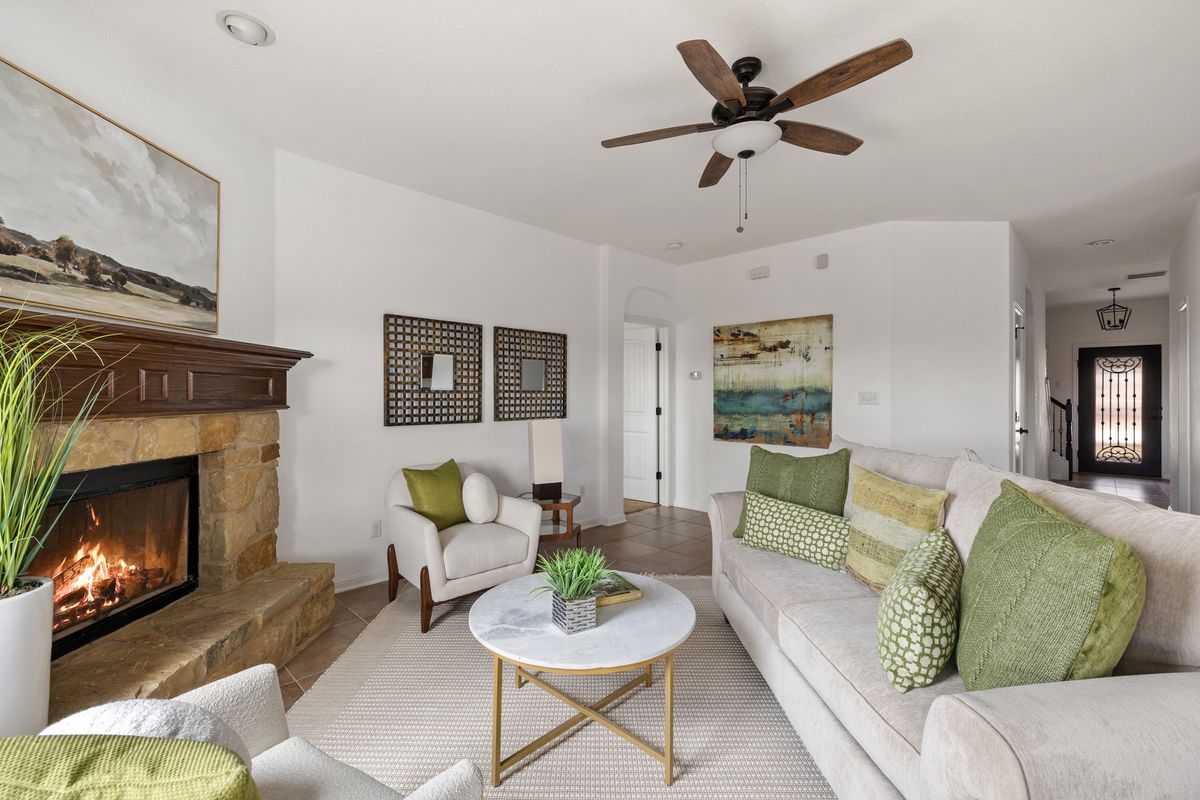 407 Stone View Trail Austin, TX 78737 - Photo 8 of 40 a living room with furniture and a fireplace