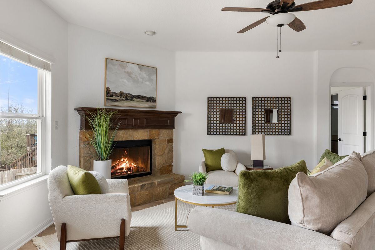 407 Stone View Trail Austin, TX 78737 - Photo 9 of 40 a living room with furniture and a fireplace