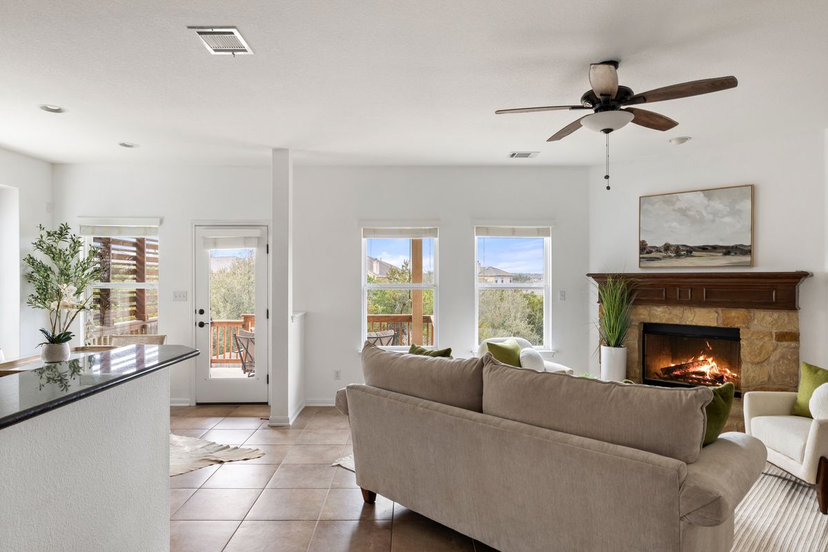 407 Stone View Trail Austin, TX 78737 - Photo 10 of 40 a living room with furniture and a fireplace