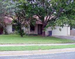 3900 Gemstone Road Austin, TX 78749 - Photo 1 of 1 a front view of a house with a garden and trees