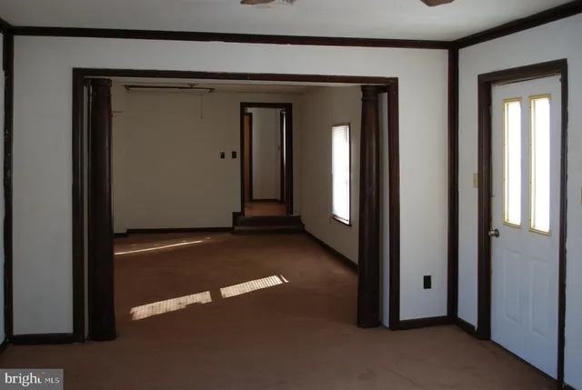 a view of a kitchen with a sink and dishwasher a refrigerator with wooden floor