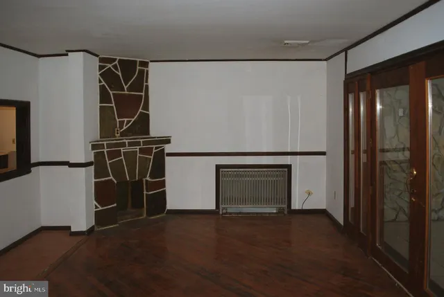 an empty room with large windows