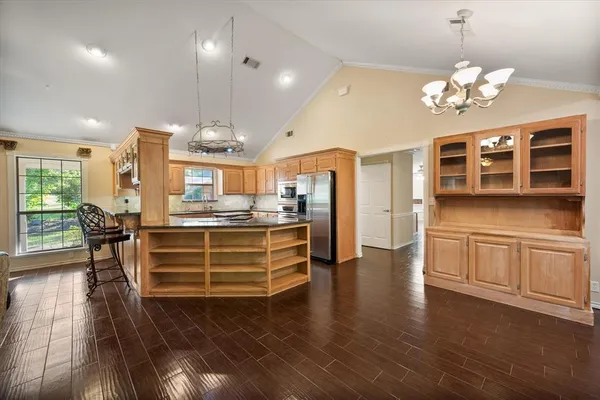a kitchen with stainless steel appliances granite countertop a stove and cabinets