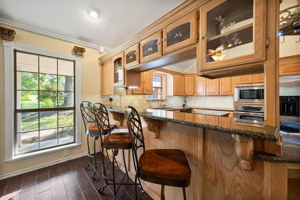 a view of a dining room with furniture a chandelier and wooden floor