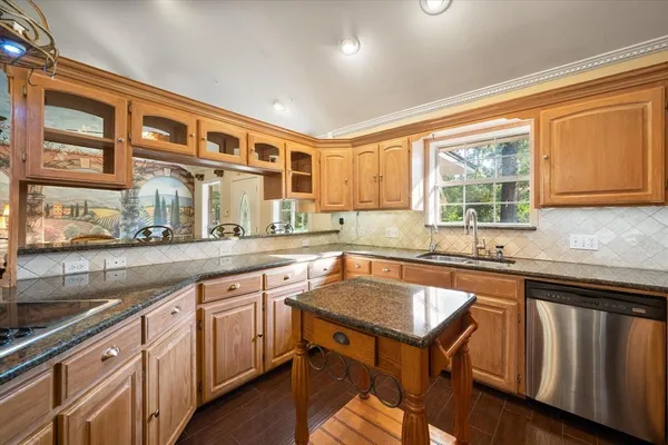 a kitchen with a sink stove and cabinets