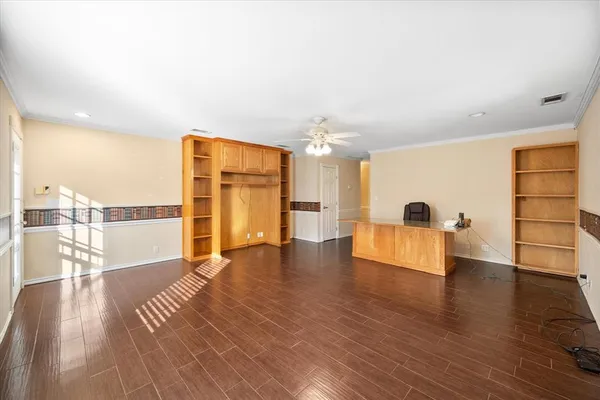 a view of a living room a dining room with furniture and wooden floor
