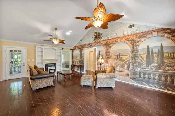 a living room with furniture and a chandelier