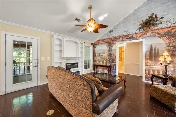 a living room with furniture a fireplace and a chandelier