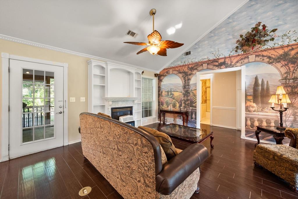 7410 County Road Kerens, TX 75144 - Photo 7 of 35 a living room with furniture a fireplace and a chandelier