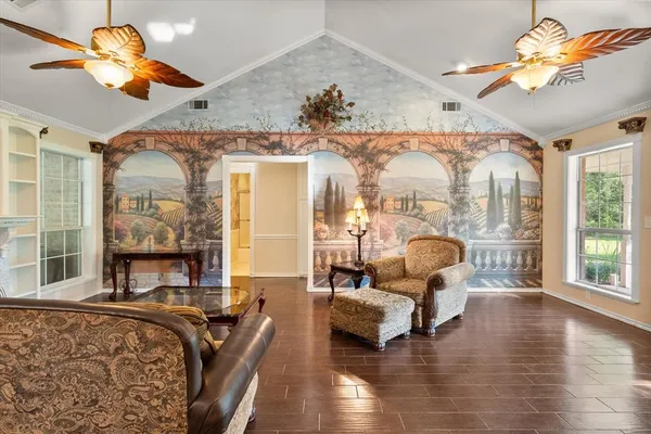 a living room with furniture chandelier and a large window