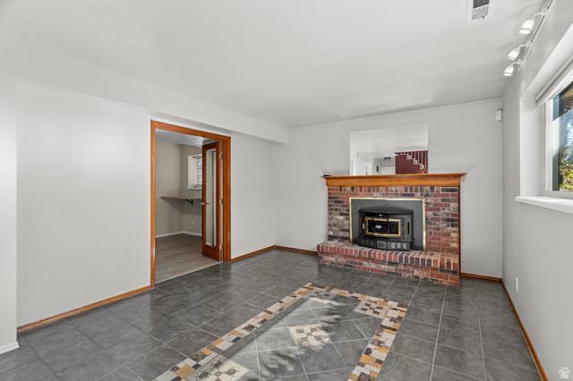 11934 South Cedar Ridge Road Sandy, UT 84094 - Photo 26 of 58 Brick fireplace with wood mantel, tile flooring with decorative inlay, French doors, and recessed lighting
