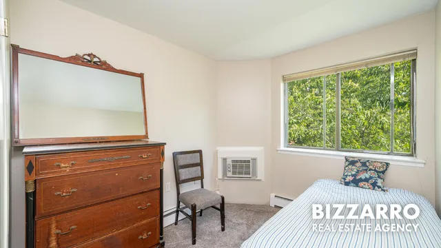 a bedroom with a bed and a dresser