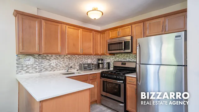 a kitchen with stainless steel appliances granite countertop a refrigerator stove a sink and dishwasher