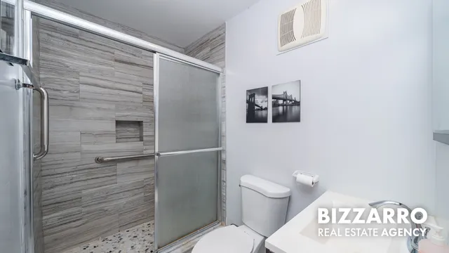 a bathroom with a toilet and a shower