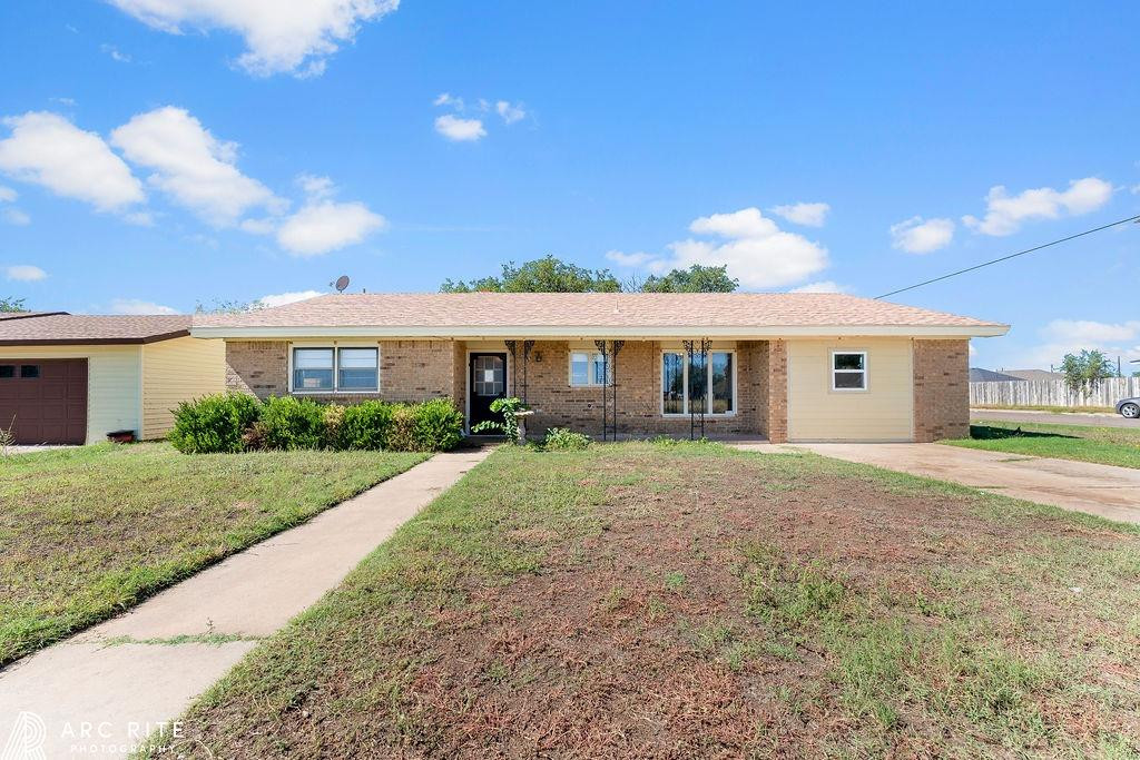 2123 North Cypress Road Lubbock, TX 79403 - Photo 1 of 22 a front view of a house with a garden