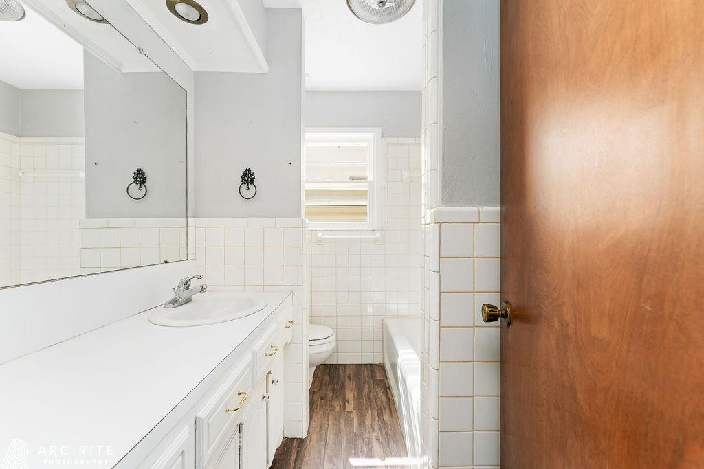 2123 North Cypress Road Lubbock, TX 79403 - Photo 12 of 22 a bathroom with a sink and a mirror