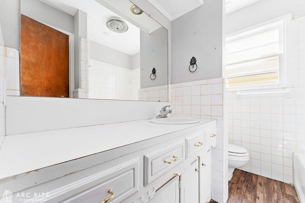2123 North Cypress Road Lubbock, TX 79403 - Photo 13 of 22 a bathroom with a sink a toilet and a mirror