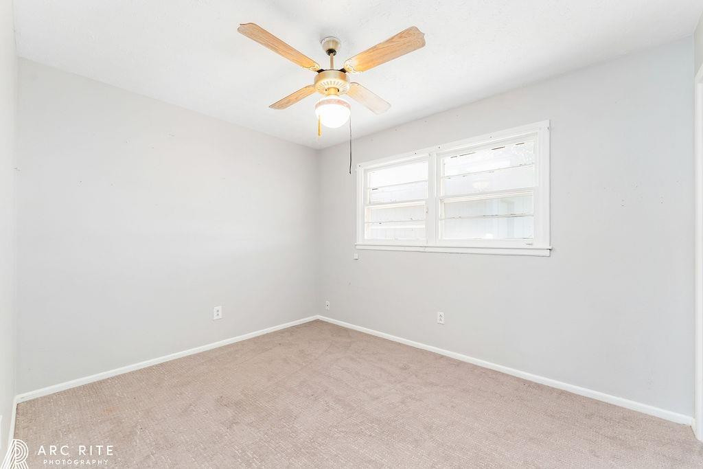2123 North Cypress Road Lubbock, TX 79403 - Photo 14 of 22 an empty room with ceiling fan and window